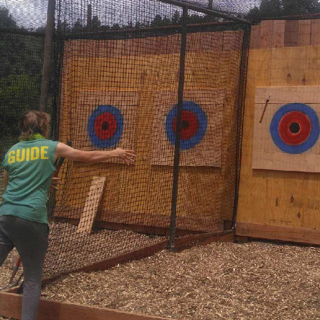 Guide at durango adventures showing how you should throw your axes