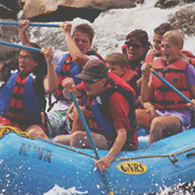 group on their rafting trip trying to tame the raft